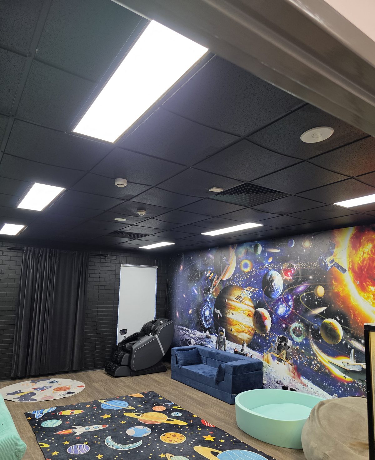 New LED panel lighting installed in a black ceiling grid at a Sydney NDIS sensory room fit-out